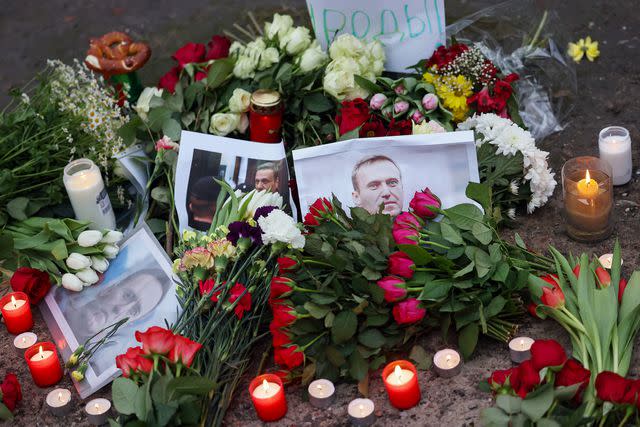 <p>HANNIBAL HANSCHKE/EPA-EFE/Shutterstock</p> Flowers, candels and portraits of Russian opposition leader Alexei Navalny are seen in front of the Russian embassy, in Berlin, Germany, 16 February 2024