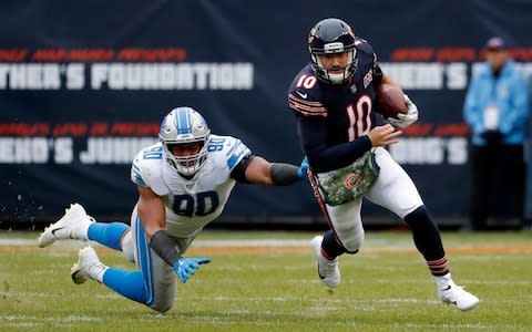 Chicago Bears quarterback Mitchell Trubisky (10) avoids a tackle byf Detroit Lions defensive end Trey Flowers (90) during the second half of an NFL football game in Chicago, Sunday, Nov. 10, 2019 - Credit: AP