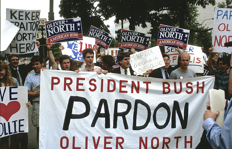 Oliver North became a conservative star after he defiantly admitted to breaking the law in the Iran-Contra scandal. His supporters rallied to his side ahead of&nbsp;his sentencing hearing in 1989. (Photo: Mark Reinstein via Getty Images)