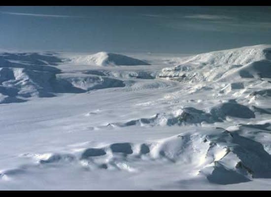 With broad bends in its upper reaches, Axel Heiberg Glacier descends steeply from the polar plateau.  En route to the South Pole, Roald Amundsen’s party drove dog teams in a zigzag pattern up the ascending ramps, avoiding the steeper icefalls of the glacier.  