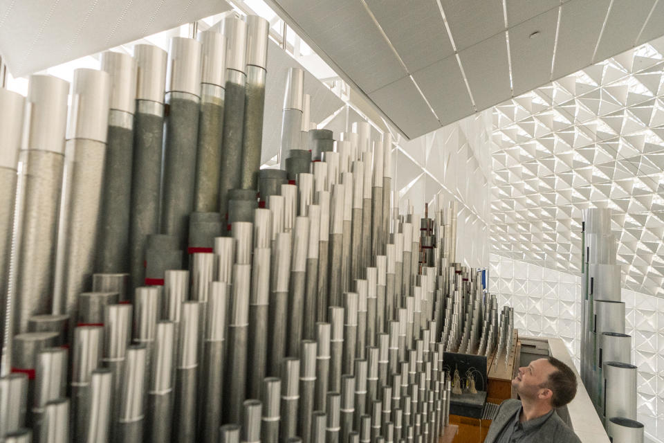 Kevin Cartwright, technician and president of Los Angeles-based Rosales Organ Builders, looks up to the highest pipes of the Hazel Wright organ at Christ Cathedral in Garden Grove, Calif., Tuesday, Feb. 15, 2022. "The organ must be tuned for the building," he said. "Each pipe must be individually tuned." That means Cartwright must climb up ladders several stories high to reach every pipe and tune each one to perfection. (AP Photo/Damian Dovarganes)