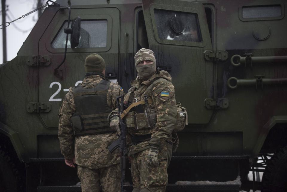 Ukrainian servicemen patrol near the humanitarian aid center in Avdiivka, Ukraine, Saturday, Feb. 4, 2017. Fighting in eastern Ukraine sharply escalated this week. Ukraine's military said several soldiers were killed over the past day in shelling in eastern Ukraine, where fighting has escalated over the past week. (AP Photo/Evgeniy Maloletka)