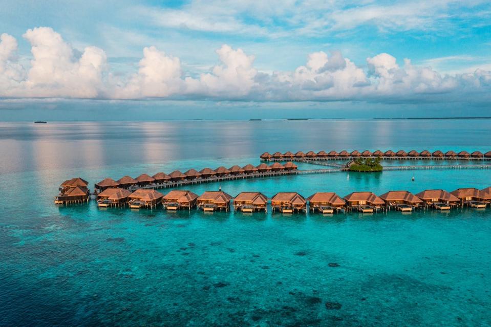 Aerial view of an overwater bungalow resort in the Maldives.