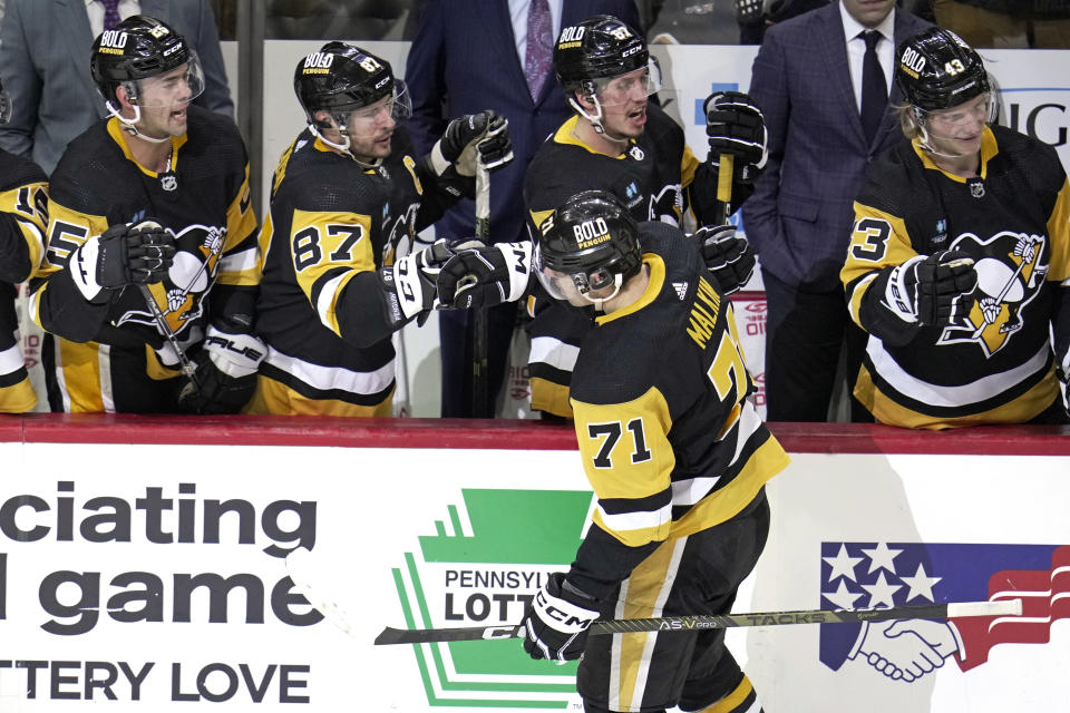 Pittsburgh Penguins' Evgeni Malkin (71) returns to the bench after scoring during the third period of an NHL hockey game against the Washington Capitals in Pittsburgh, Saturday, March 25, 2023. (AP Photo/Gene J. Puskar)