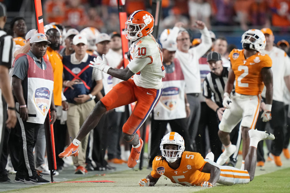 Clemson wide receiver Joseph Ngata (10) runs for a first down past Tennessee defensive back Kamal Hadden (5) during the first half of the Orange Bowl NCAA college football game Friday, Dec. 30, 2022, in Miami Gardens, Fla. (AP Photo/Lynne Sladky)