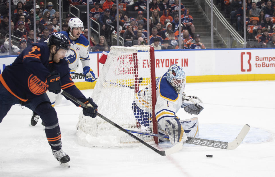 Buffalo Sabres goalie Ukko-Pekka Luukkonen (1) makes the save against Edmonton Oilers' Warren Foegele (37) during second-period NHL hockey game action in Edmonton, Alberta, Thursday March 21, 2024. (Jason Franson/The Canadian Press via AP)