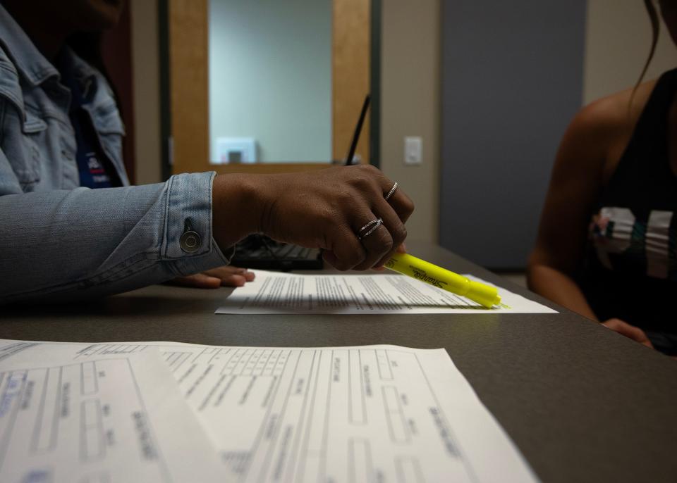 Nakeisha Ellis, left, a U.S. Small Business Administration customer service representative, informs Jade Bieniak, right, of Deer Point, Fla., about how to apply for low-interest disaster loans from the U.S. Small Business Administration at the Bay County Public Library in Panama City on April 2.