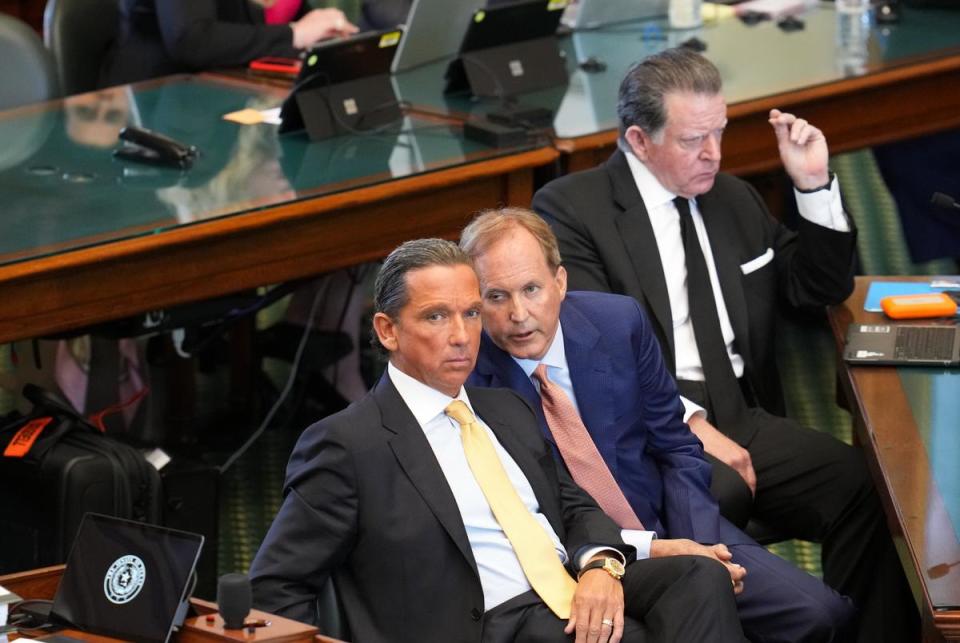 Suspended Attorney General Ken Paxton confers with defense attorney Tony Buzbee during the first day of the impeachment trial in the Texas Senate chamber on Sept. 5, 2023.