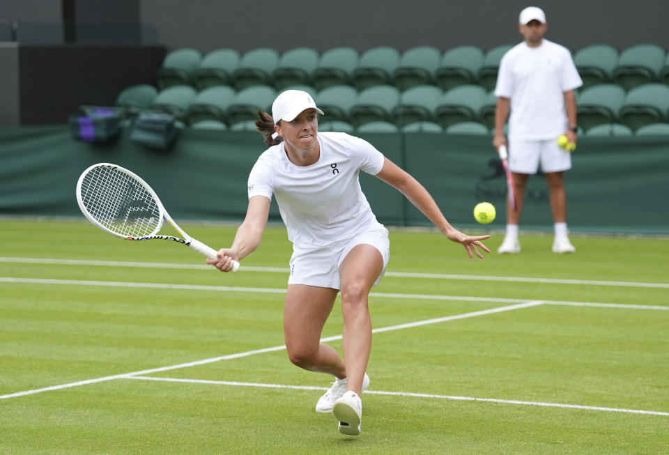 Poland's Iga Swiatek plays a volley on the practice court at the All England Lawn Tennis and Croquet Club ahead of the Wimbledon Championships, which begins on July 1st, in London, Friday June 28, 2024. (Zac Goodwin/PA via AP)