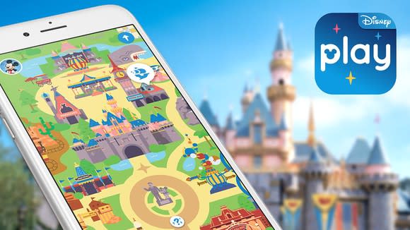 Play Disney Parks app with Disneyland's castle in the background.