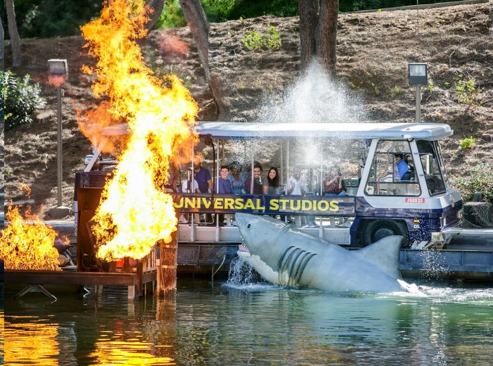 a truck with a large whale coming out of the water