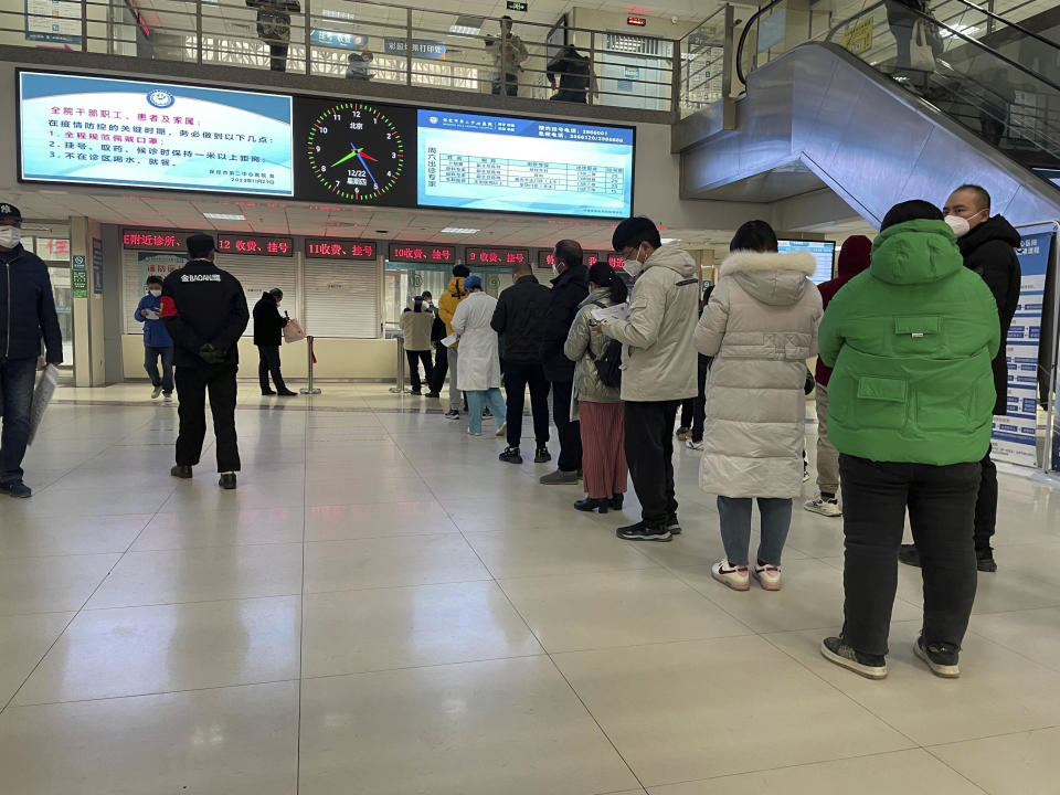 Visitors line up at the cash counters in Baoding No. 2 Central Hospital in Zhuozhou city in northern China's Hebei province on Wednesday, Dec. 21, 2022. China only counts deaths from pneumonia or respiratory failure in its official COVID-19 death toll, a Chinese health official said, in a narrow definition that limits the number of deaths reported, as an outbreak of the virus surges following the easing of pandemic-related restrictions. (AP Photo)