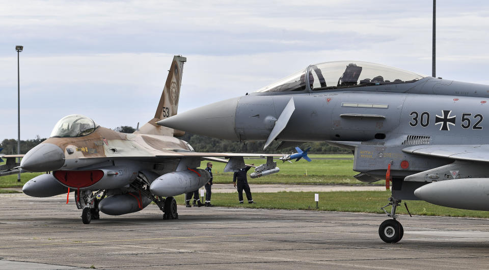 A German Eurofighter, right, parks beside a F16 jet from Israel, left, at the airbase in Noervenich, Germany, Thursday, Aug. 20, 2020. Pilots from Israel and Germany will fly together the next two weeks during the first joint military Air Force exercises between the two nations in Germany. (AP Photo/Martin Meissner)