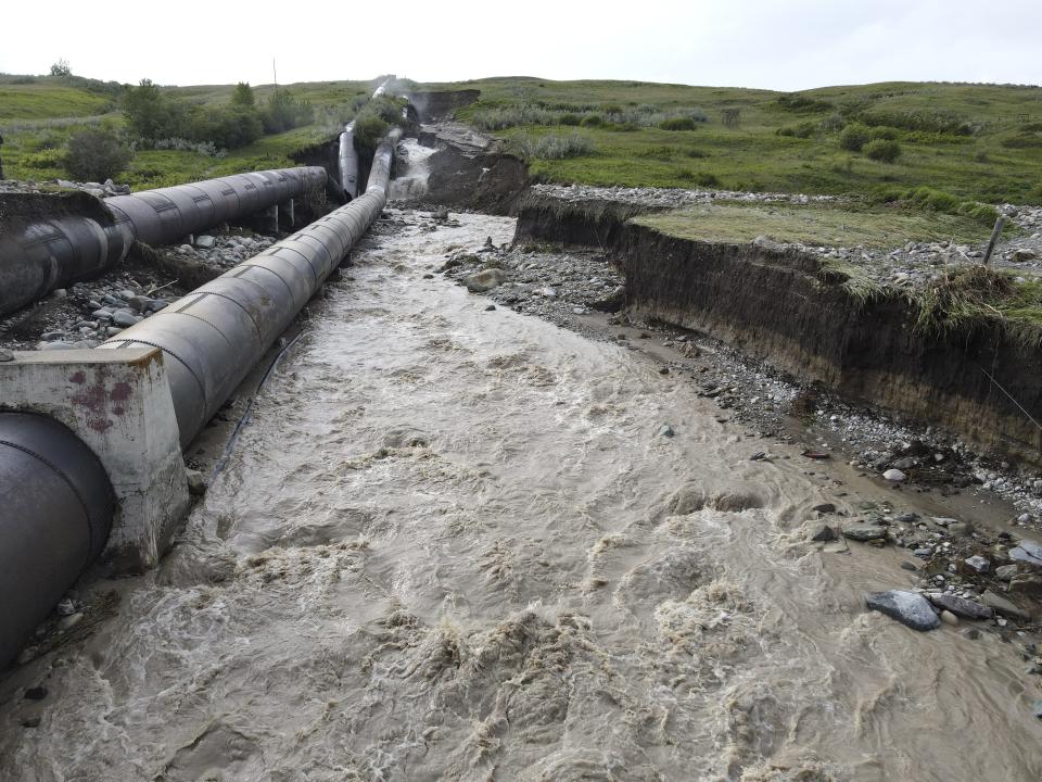 This photo released by the Bureau of Reclamation Missouri Basin Region, Montana Area Office, shows a breach in the St. Mary Canal siphon in Babb, Montana, Monday, June 17, 2024. The siphon is part of a system that carries water from a river on the Blackfeet Indian Reservation to another river that provides irrigation water to farmers and drinking water to 14,000 residents in northern Montana. No injuries or deaths have been reported since the century-old pipes broke open Monday. Officials do not know how long it will take to repair the damage. (Bureau of Reclamation Missouri Basin Region, Montana Area Office via AP)