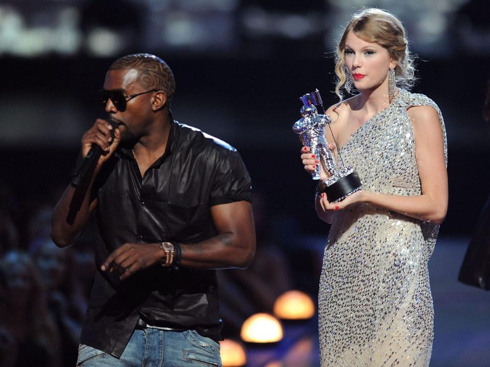 Kanye West takes the microphone from Taylor Swift and speaks onstage during the 2009 MTV Video Music Awards at Radio City Music Hall on September 13, 2009 in New York City.