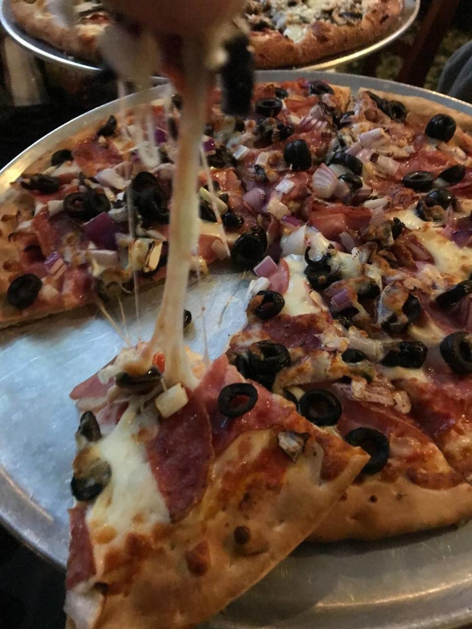 This 8-inch mini “build-your-own” gluten-free pizza at Luigi’s Pizza in Cambria produces an impressive “cheese pull” from the melted mozzarella cheese. The pull from a nearby 16-inch large stretched out to more than a foot.