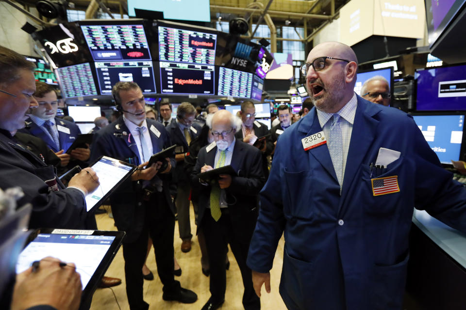 Specialist Peter Giacchi, right, calls out prices on the New York Stock Exchange trading floor before the Slack IPO, Thursday, June 20, 2019. The San Francisco company is set to start trading Thursday in what's known as a direct listing. (AP Photo/Richard Drew)