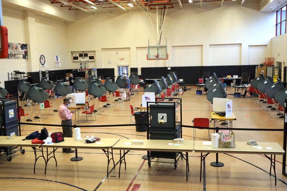 Voting booths are spaced out for social distancing at a polling site Monday, June 29, 2020, in Houston. Early voting for the Texas primary runoffs began Monday. (AP Photo/David J. Phillip)