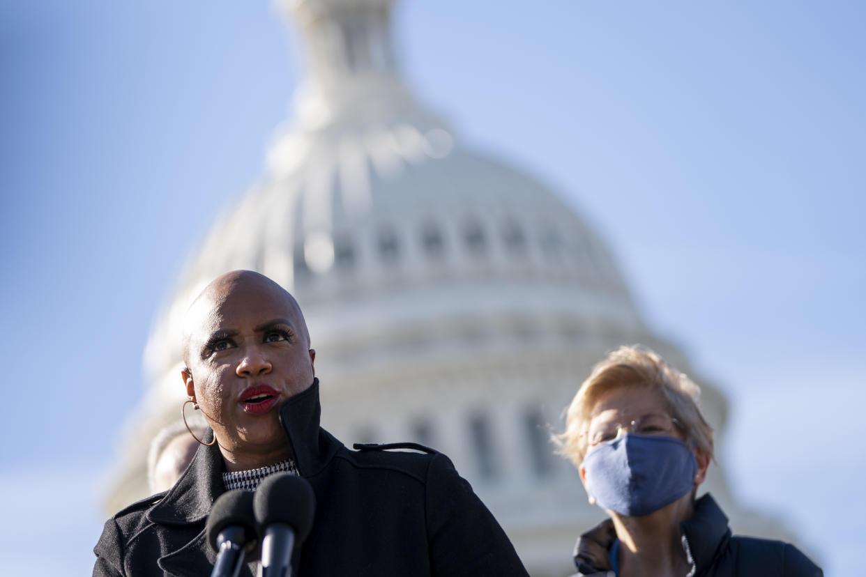 WASHINGTON, DC - FEBRUARY 4: (L-R) Rep. Ayanna Pressley (D-MA) speaks as Sen. Elizabeth Warren (D-MA) looks on during a press conference about student debt outside the U.S. Capitol on February 4, 2021 in Washington, DC. The group of Democrats re-introduced their resolution calling on President Joe Biden to take executive action to cancel up to $50,000 in debt for federal student loan borrowers. (Photo by Drew Angerer/Getty Images)