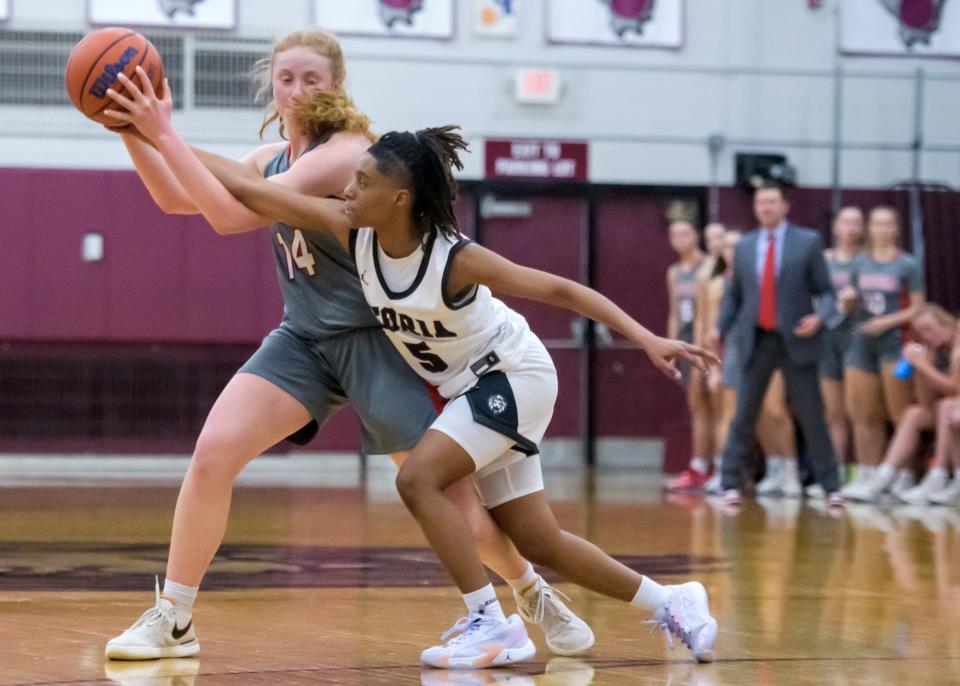 Morton's Addy Engel (14) tangles with Peoria High's Danielle Ruffin in the first half of their girls basketball game Tuesday, Nov. 14, 2023 at Peoria High School. The Lions defeated the Potters 53-48.