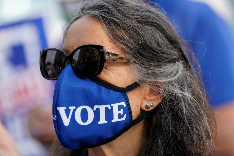 Irene Huber joins others during the "Save the Post Office" rally in Salt Lake City. 