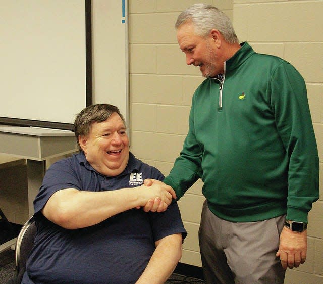 Bartlesville Sports Commission member Tim Bart congratuates Bartlesville Examiner-Enterprise Sports Editor Mike Tupa earlier this year after it was announced that Tupa would be enshrined in the Bartlesville Athletics Hall of Fame. File photo