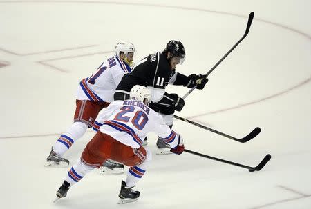 Los Angeles Kings center Anze Kopitar (11) battles for the puck between New York Rangers center Derek Stepan (21) and left wing Chris Kreider (20) during the second period in game five of the 2014 Stanley Cup Final at Staples Center. Jun 13, 2014; Los Angeles, CA, USA; Richard Mackson-USA TODAY Sports