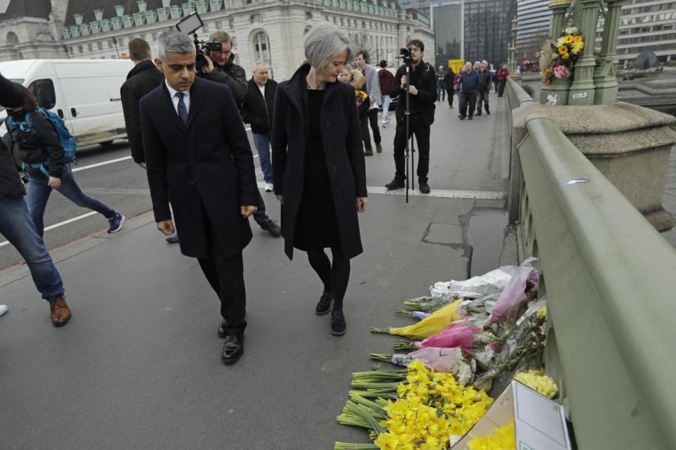 Sadiq Khan walks on Westminster Bridge near floral tributes (AP)