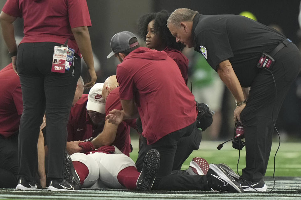 Arkansas head coach Sam Pittman, right, looks on as defensive lineman John Morgan III (6) is woked on after he collapsed during the second half of an NCAA college football game against Texas A&M, Saturday, Sept. 30, 2023, in Arlington, Texas. (AP Photo/LM Otero)