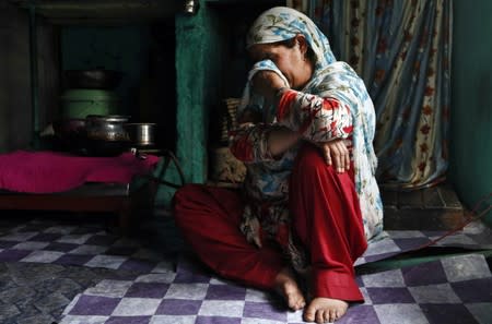 Haseena Malik, mother of Uzair Maqbool Malik, reacts while speaking about her son inside her kitchen in south Kashmir's Shopian