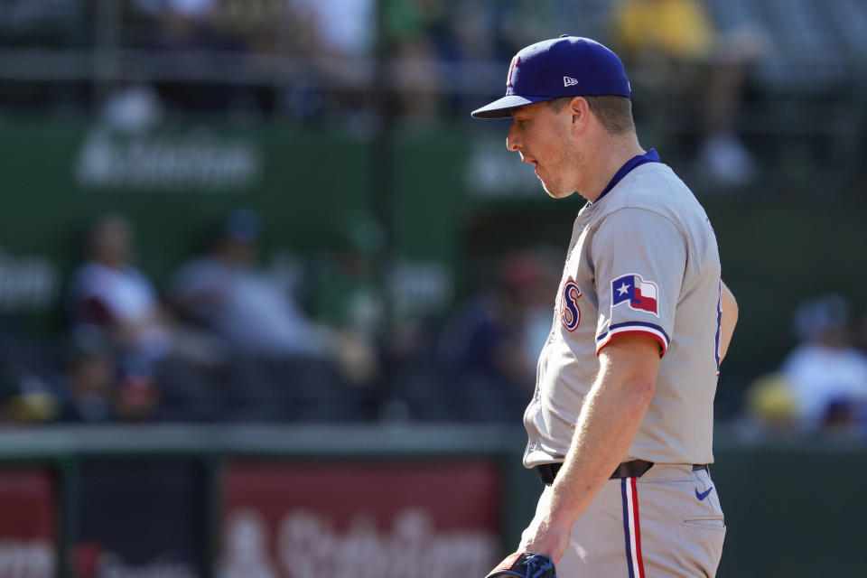 Texas Rangers pitcher Josh Sborz walks off the field with an injury during the sixth inning in the second baseball game of the team's doubleheader against the Oakland Athletics, Wednesday, May 8, 2024, in Oakland, Calif. (AP Photo/Godofredo A. Vásquez)