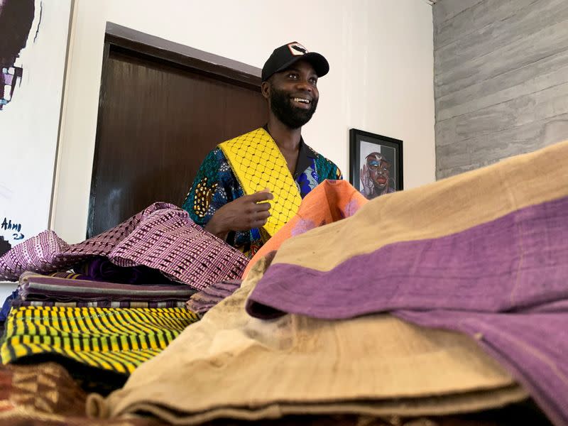 Fashion designer Tsemaye Binitie holds his custom Aso-Oke fabric during a workshop in Lagos