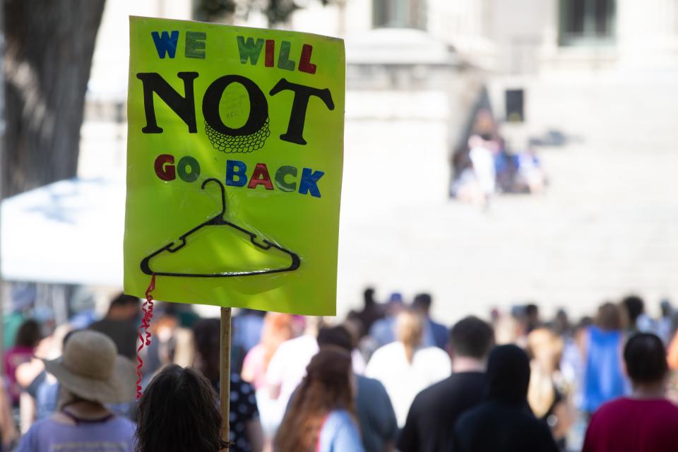 A womans abortion-rights stands out during a rally at the Kansas Statehouse on July 30, 2022.