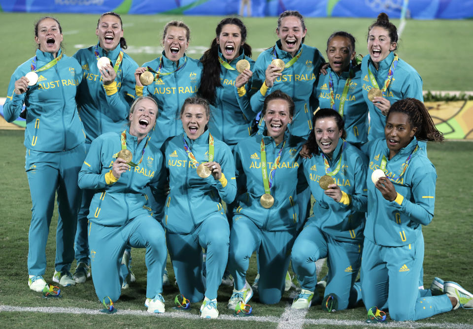 FILE - In this Aug. 8, 2016, file photo, Australia's players celebrate after winning the women's rugby sevens gold medal match against New Zealand at the Summer Olympics in Rio de Janeiro, Brazil. It was rugby in fast forward and it generated millions of new fans across the world. Rugby sevens made its Olympic debut in Rio de Janeiro in 2016 bringing all the usual hard-hitting tackles, collisions and swerving runs but leaving out the slow-mo elements of the traditional 15-a-side game. (AP Photo/Themba Hadebe, File)