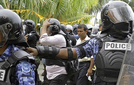 A handout photograph from the Maldivian Democratic Party (MDP) shows Maldivian police officers arresting former Maldives president Mohamed Nasheed (second right) in Fares Maathodaa. Nasheed was detained after he failed to turn up at his trial for abuse of power, his party said