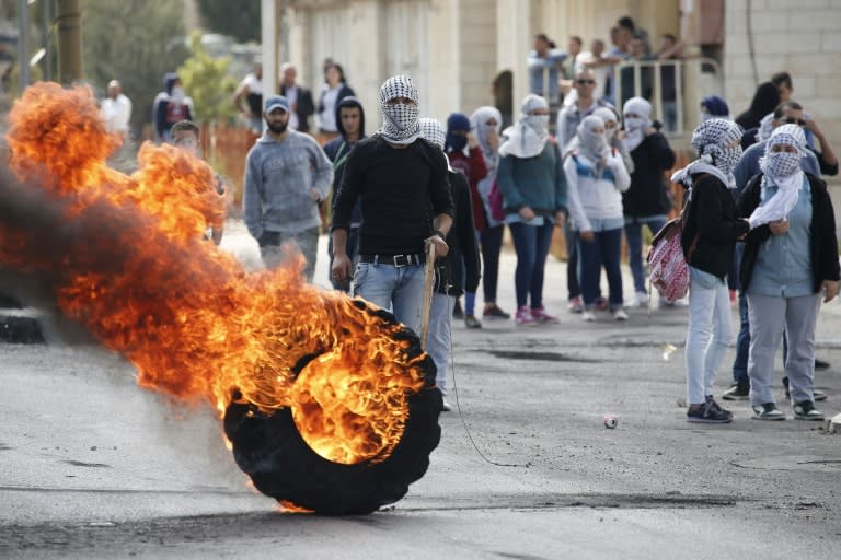 Palestinian stone throwers clash with Israeli security forces (unseen) in the Jewish settlement of Beit El in the occupied West Bank, on October 8, 2015