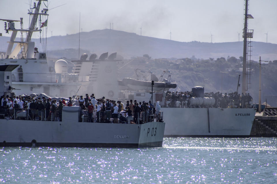 Migrants arrive in Porto Empedocle, Sicily, aboard two military ships after being transferred from the island of Lampedusa, where a number of small boat carrying migrants arrived in the last days, Monday, July 27, 2020. (Fabio Peonia/LaPresse via AP)