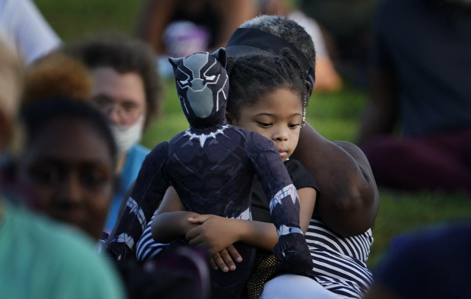 Khloe Murray, 5, of South Carolina, holds her Black Panther doll during a Chadwick Boseman Tribute on Thursday, Sept. 3, 2020, in Anderson, S.C. (AP Photo/Brynn Anderson)