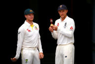 England's cricket team captain Joe Root holds a replica Ashes urn as he stands next to Australia's cricket team captain Steve Smith during an official event ahead of the Ashes opening test match at the GABBA ground in Brisbane, Australia, November 22, 2017. REUTERS/David Gray