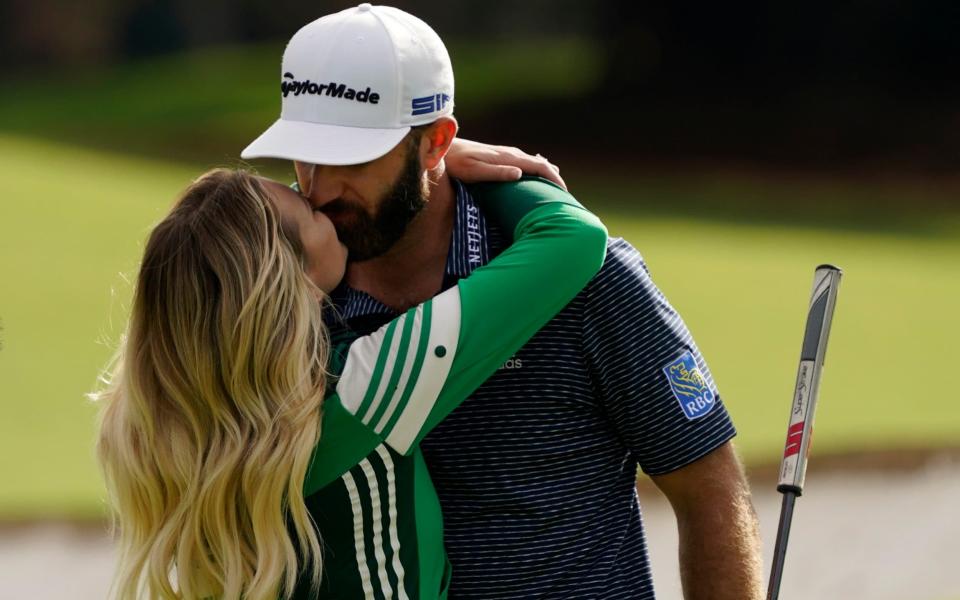 Dustin Johnson is hugged by his wife Pauline Gretzky - AP