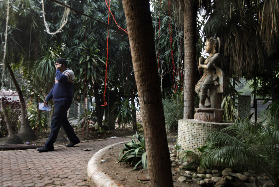 An Indian investigator speaks on his phone at the spot which police say is where a Danish tourist was gang-raped in New Delhi, India, Wednesday, Jan. 15, 2014. A 51-year-old Danish tourist was gang-raped Tuesday near a popular shopping area in New Delhi after she stopped to ask for directions, police said Wednesday, the latest case to focus attention on the scourge of violence against women in India. The woman managed to reach her hotel Tuesday evening and the owner called police. (AP Photo/Altaf Qadri)