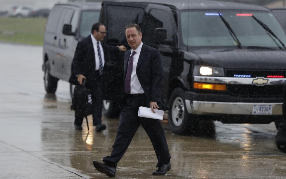 Reince Priebus walks to boards Air Force One at Andrews Air Force Base to travel with Donald Trump to Brentwood, New York - Credit: AP