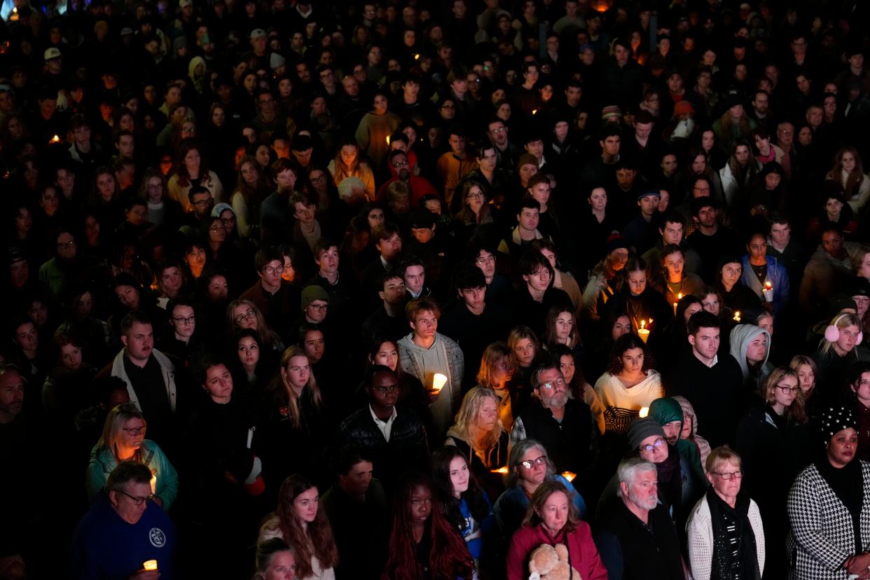 People gather at a vigil for the victims of Wednesday's mass shootings, Sunday, Oct. 29, 2023, outside the Basilica of Saints Peter and Paul in Lewiston, Maine.