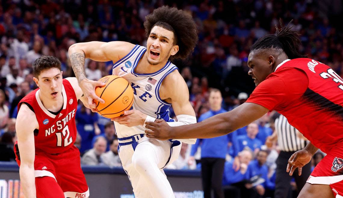 Duke’s Tyrese Proctor (5) drives past N.C. State’s DJ Burns Jr. (30) and Michael O’Connell (12) during the first half of N.C. State’s game against Duke in their NCAA Tournament Elite Eight matchup at the American Airlines Center in Dallas, Texas, Sunday, March 31, 2024.