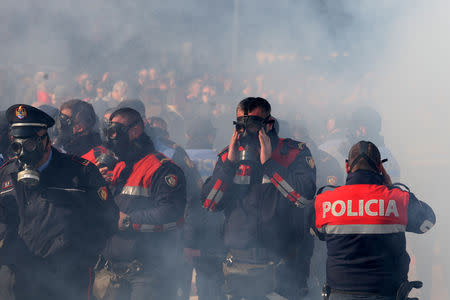 Police wear gas masks during an anti-government protest in front of the office of Albanian Prime Minister Edi Rama in Tirana, Albania, February 16, 2019. REUTERS/Florion Goga