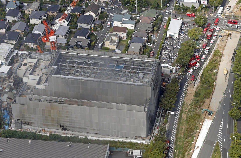 Smoke rises from a building under construction in Tama, Tokyo's western suburbs, Thursday, July 26, 2018. The fire broke out Thursday afternoon, injuring a number of people at the building. (Kyodo News via AP)