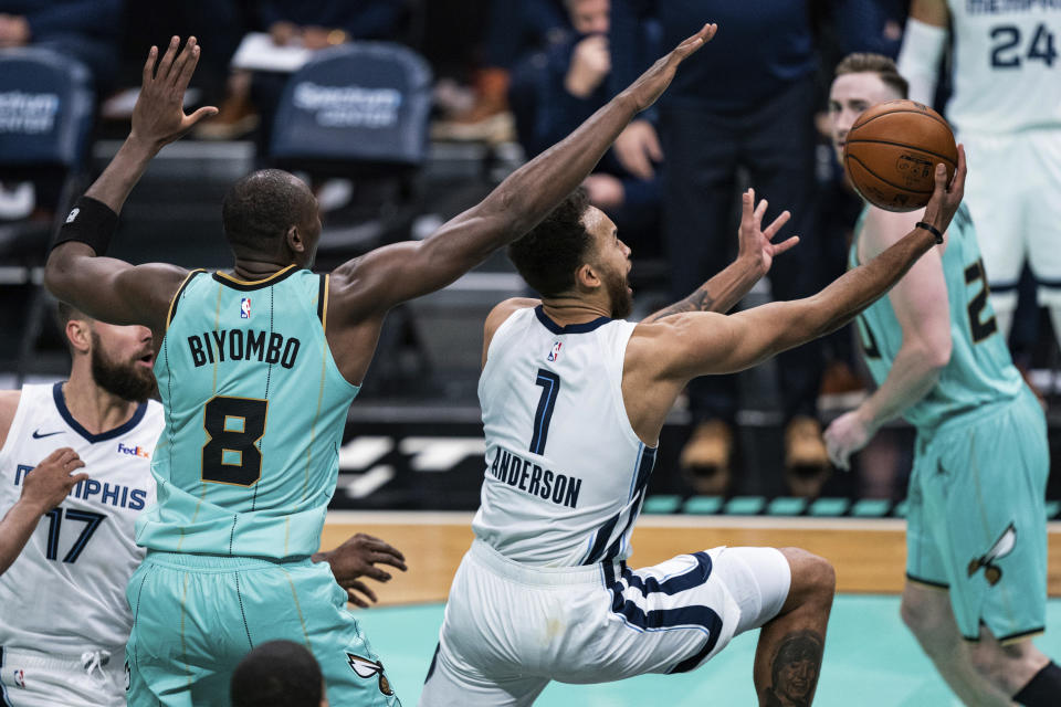 Memphis Grizzlies forward Kyle Anderson (1) drives to the basket around Charlotte Hornets center Bismack Biyombo (8) during the second half of an NBA basketball game in Charlotte, N.C., Friday, Jan. 1, 2021. (AP Photo/Jacob Kupferman)
