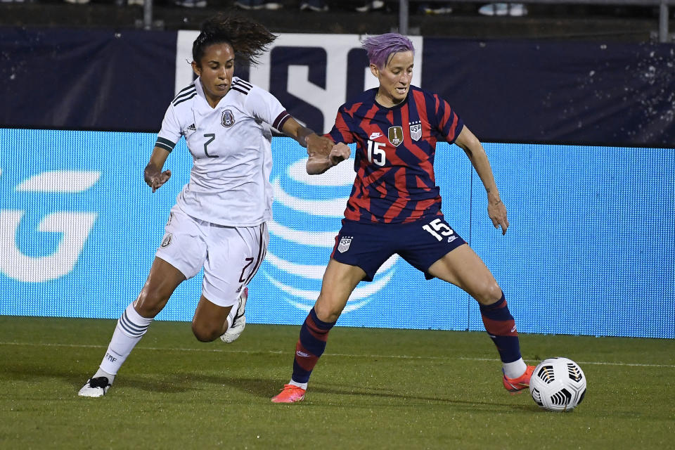 United States' Megan Rapinoe controls the ball as Mexico's Bianca Sierra defends during the first half of an international friendly soccer match, Thursday, July 1, 2021, in East Hartford, Conn. (AP Photo/Jessica Hill)