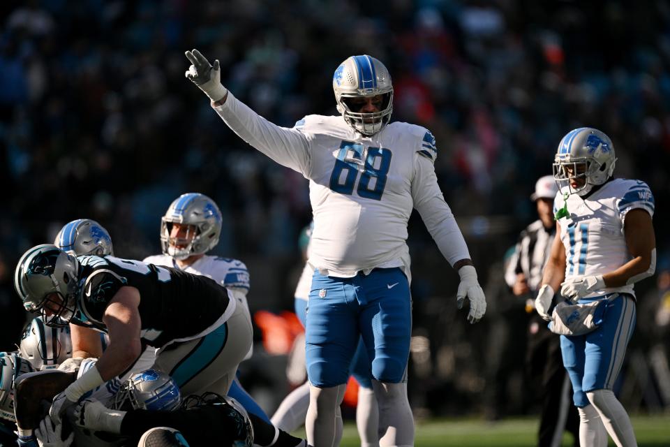 Taylor Decker (68) of the Detroit Lions signals after a play against the Carolina Panthers during the first half of the game at Bank of America Stadium on December 24, 2022 in Charlotte, North Carolina.