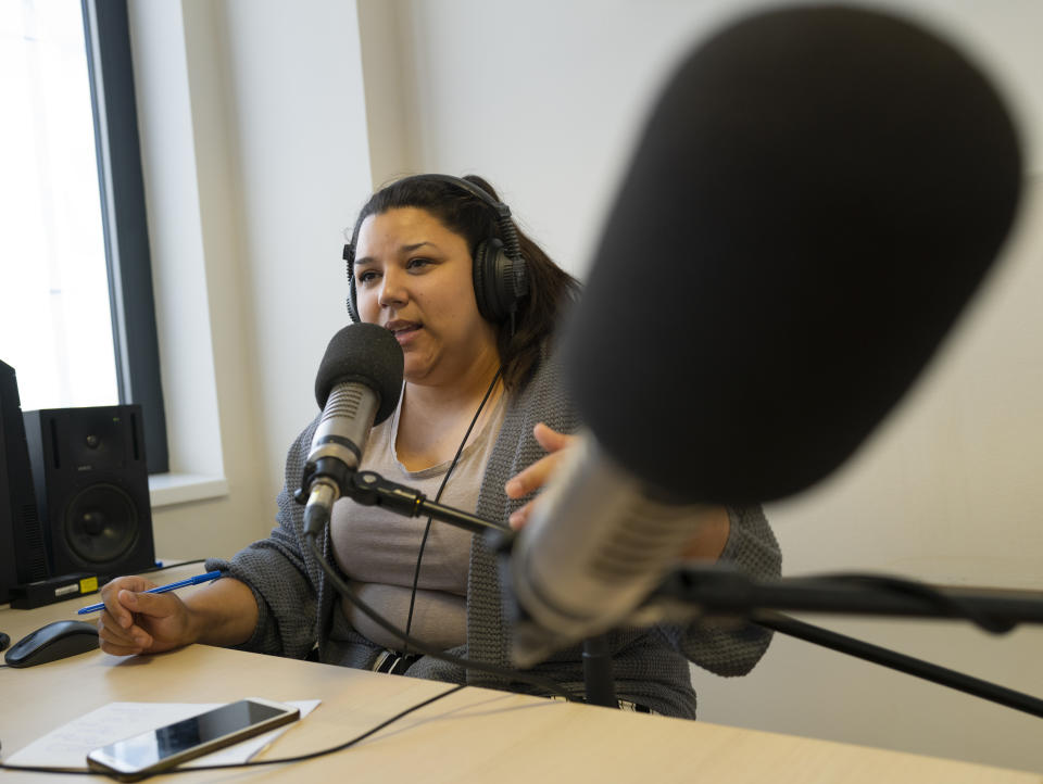 Bettina Pocsai, co-host of Radio Dikh's women's show 'Our Voice' works in a radio studio in Budapest, Hungary, Friday May 6, 2022. Intellectuals, broadcasters and cultural figures from Hungary’s Roma community have founded a radio station to reframe narratives and elevate the voices of their marginalized minority group. (AP Photo/Bela Szandelszky)